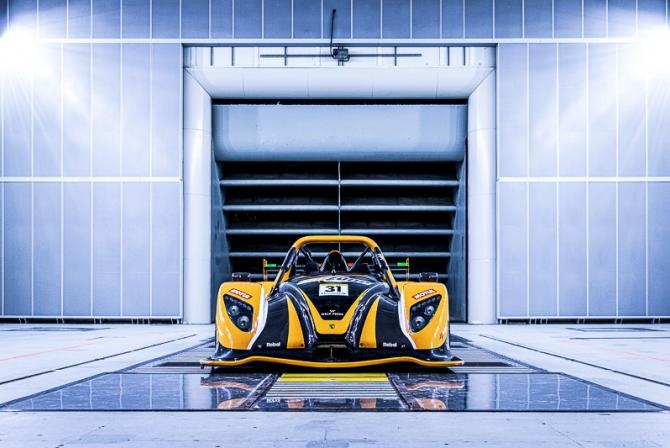 Yellow race car in a test chamber