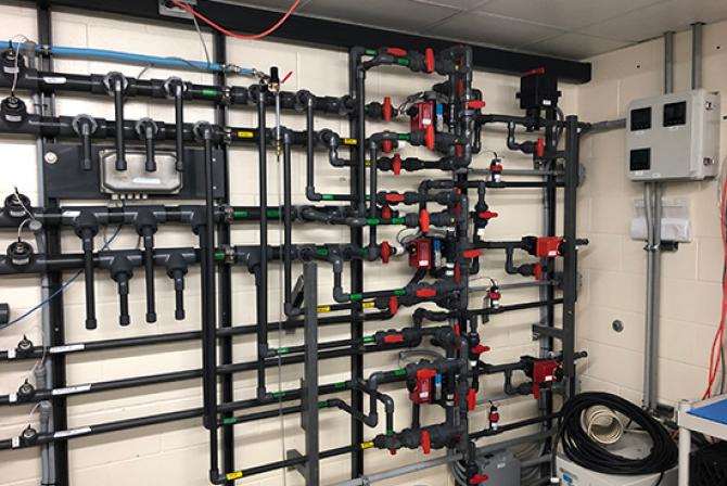 A wall of water supply pipes for research aquariums