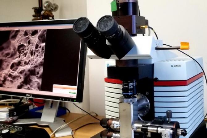 Microscopy instrumentation and monitor on a desk