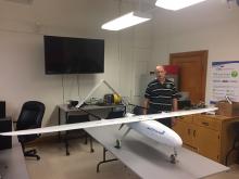 Researcher in the lab with the Uncrewed Aerial Vehicle.